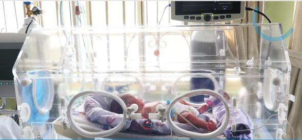 Newborn receiving care in a neonatal incubator at Nisa Premier Hospital